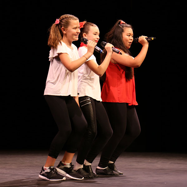 three girls singing