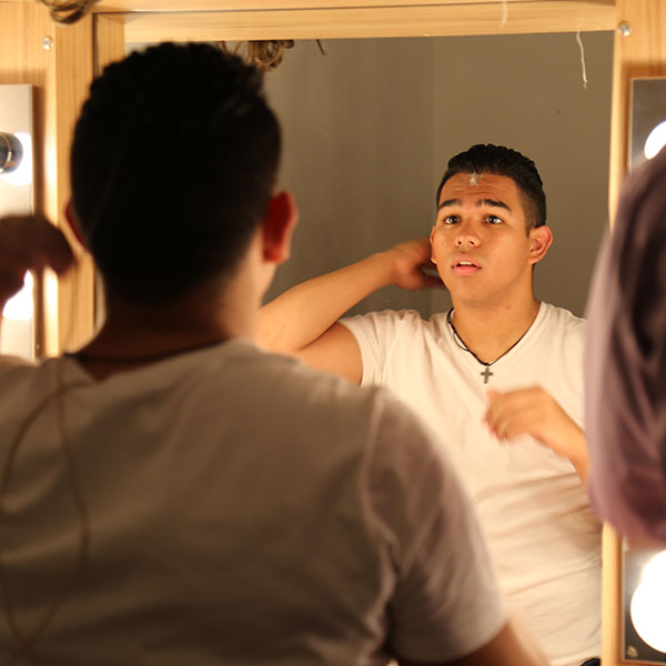 male student looking in a mirror