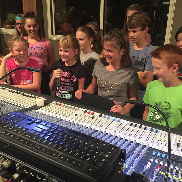 group of kids in a recording studio