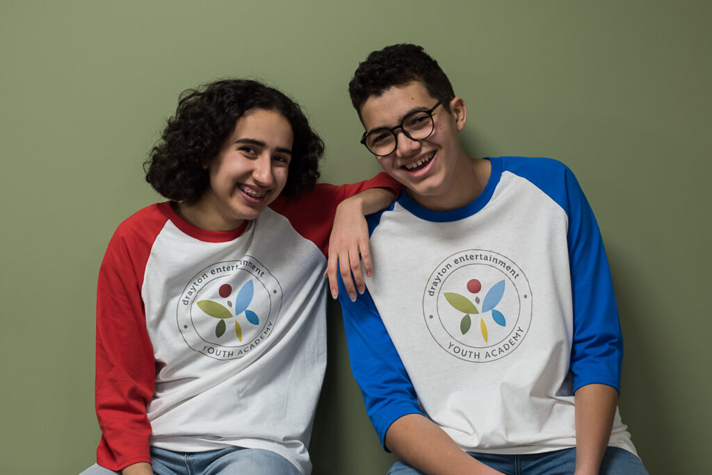Two youth wearing baseball t-shirts