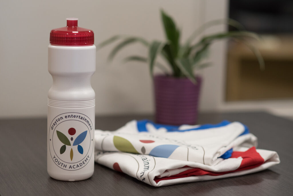 Water bottle and t-shirt folded on desk